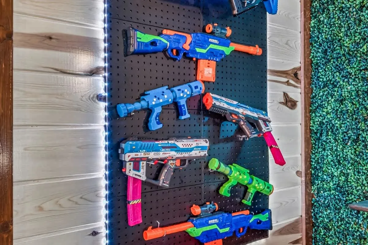 Kids' Nerf battle wall at Big Star Lodge stocked with foam blasters
