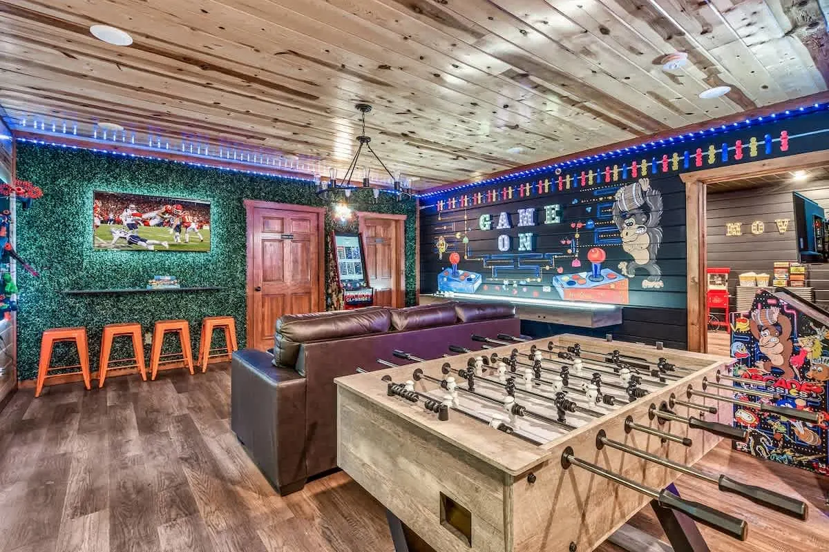 Game room at Big Star Lodge with foosball, bar stools and arcade cabinets