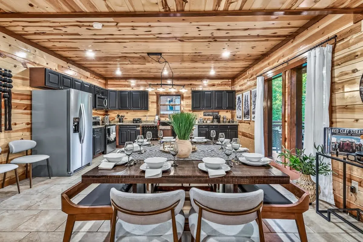 Kitchen and dining space at Big Star Lodge with island seating and a full-size fridge