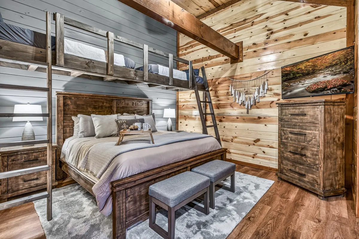 King bedroom at Big Star Lodge with built in loft bunks and a wood ladder