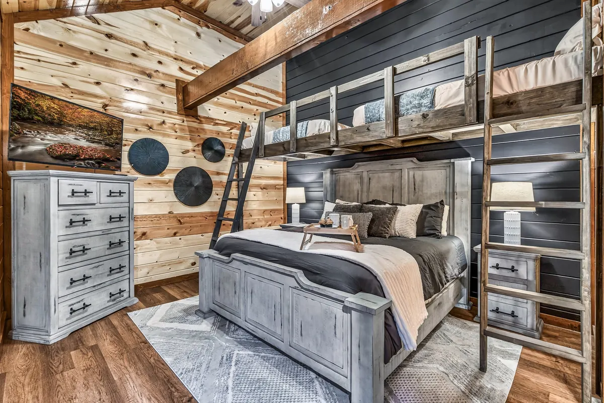 King bedroom at Big Star Lodge with a grey wood bed and loft bunk above