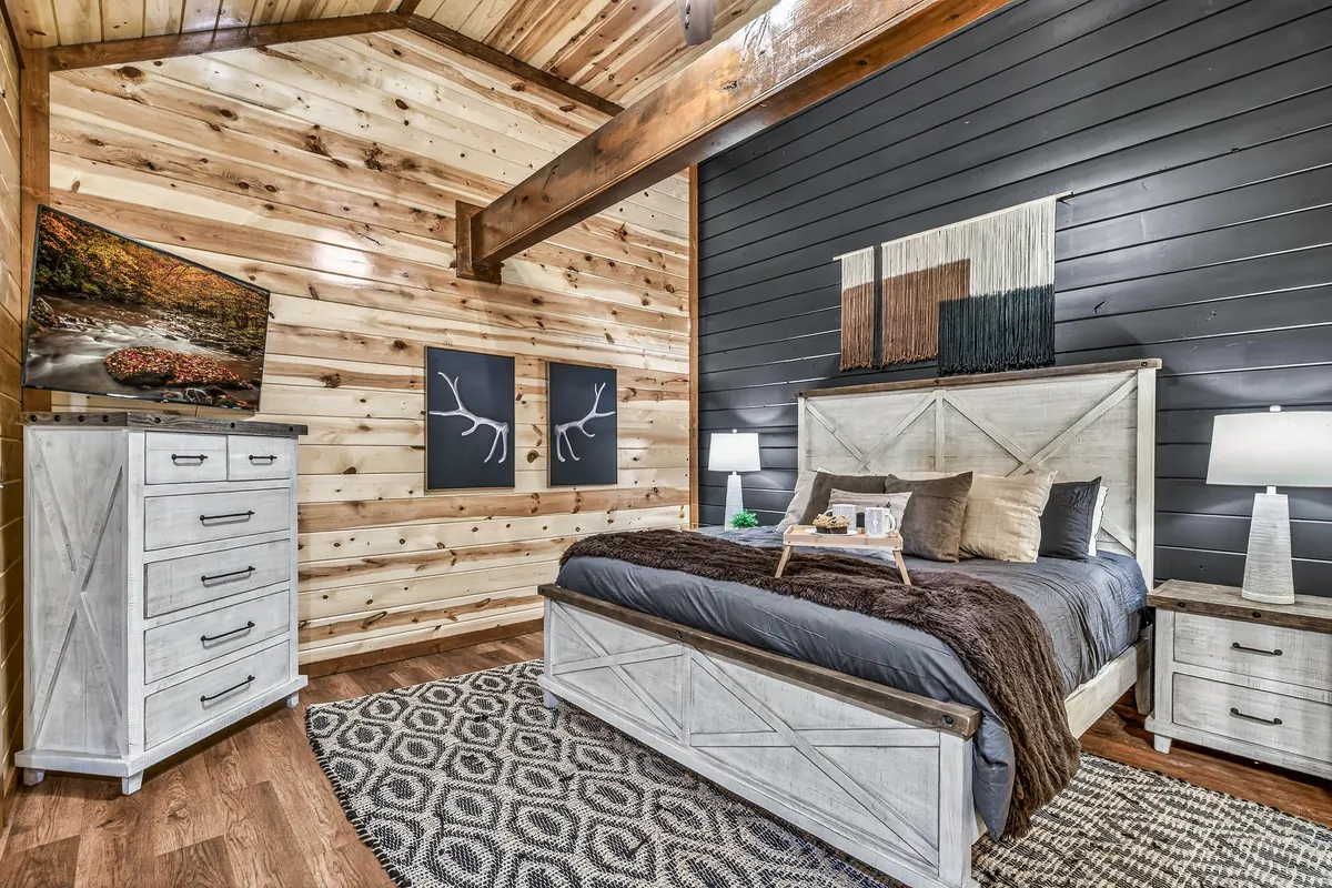 King bedroom at Big Star Lodge with a barn door headboard and dark accent wall