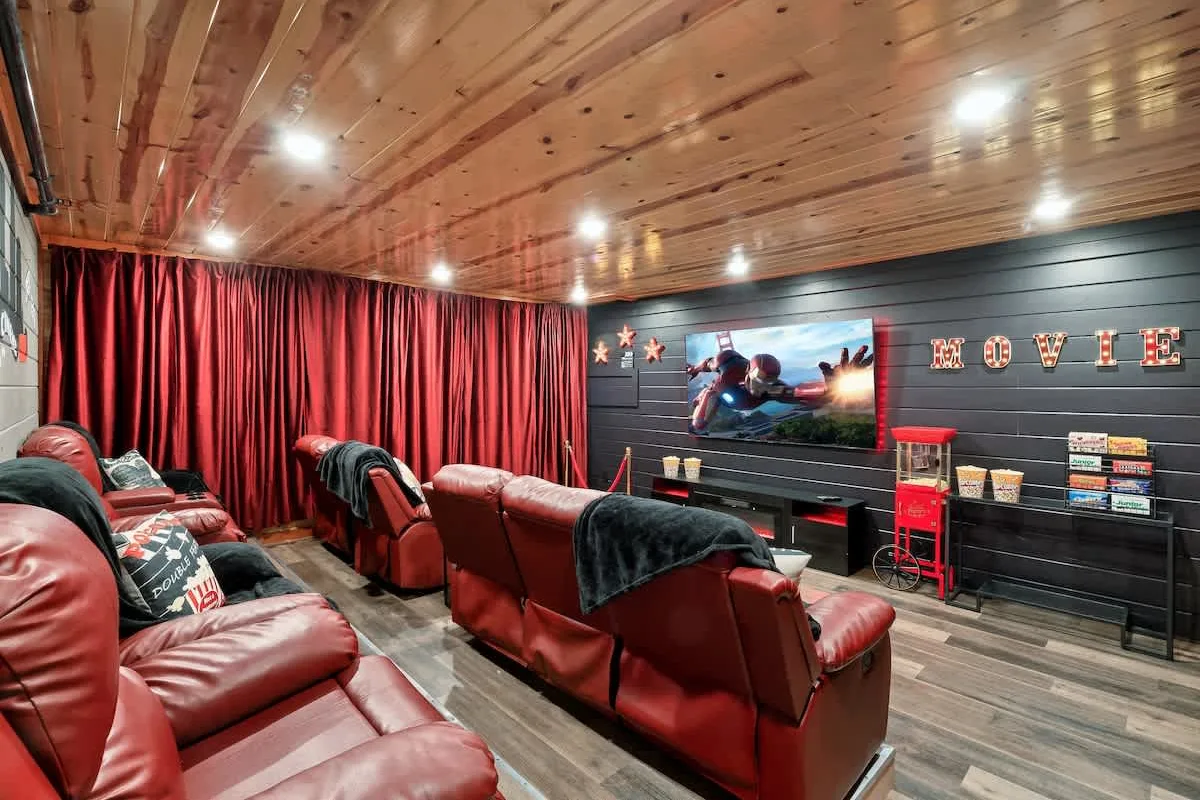 Theater room at Blackhawk Lodge with red leather recliners and a concession shelf