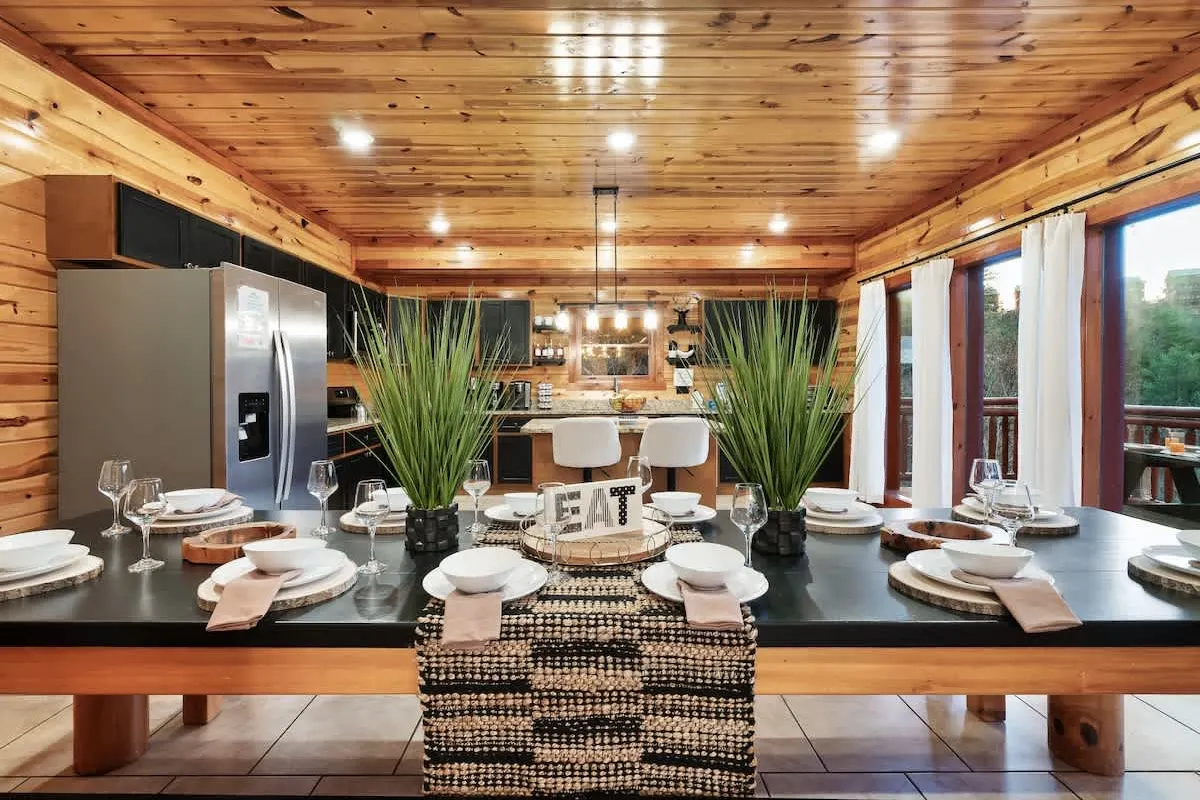 Kitchen and dining at Blackhawk Lodge with a long table set for a group