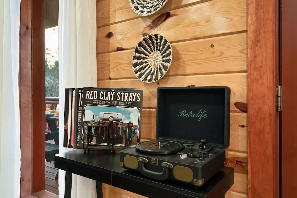 Record player and vinyl on a console table at Blackhawk Lodge