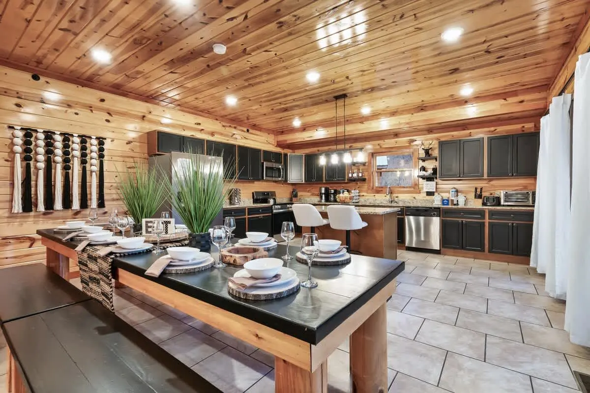 Kitchen island and dining setting at Blackhawk Lodge under a wood ceiling