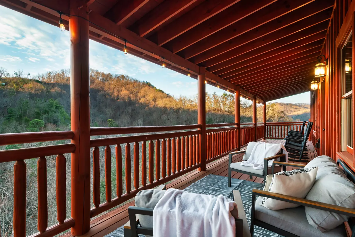 Covered deck at Blackhawk Lodge with outdoor seating and a mountain view
