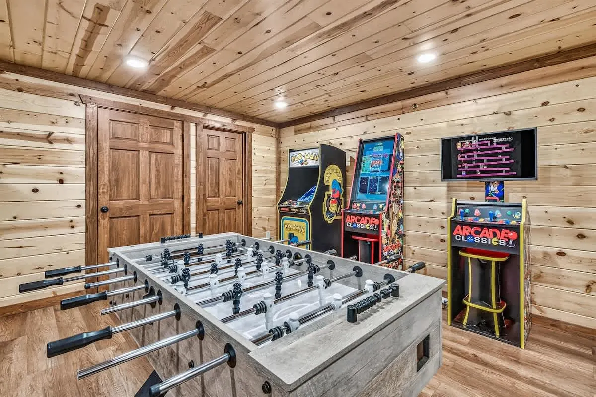 Game room at Blue Smoke Lodge with a foosball table and arcade cabinets