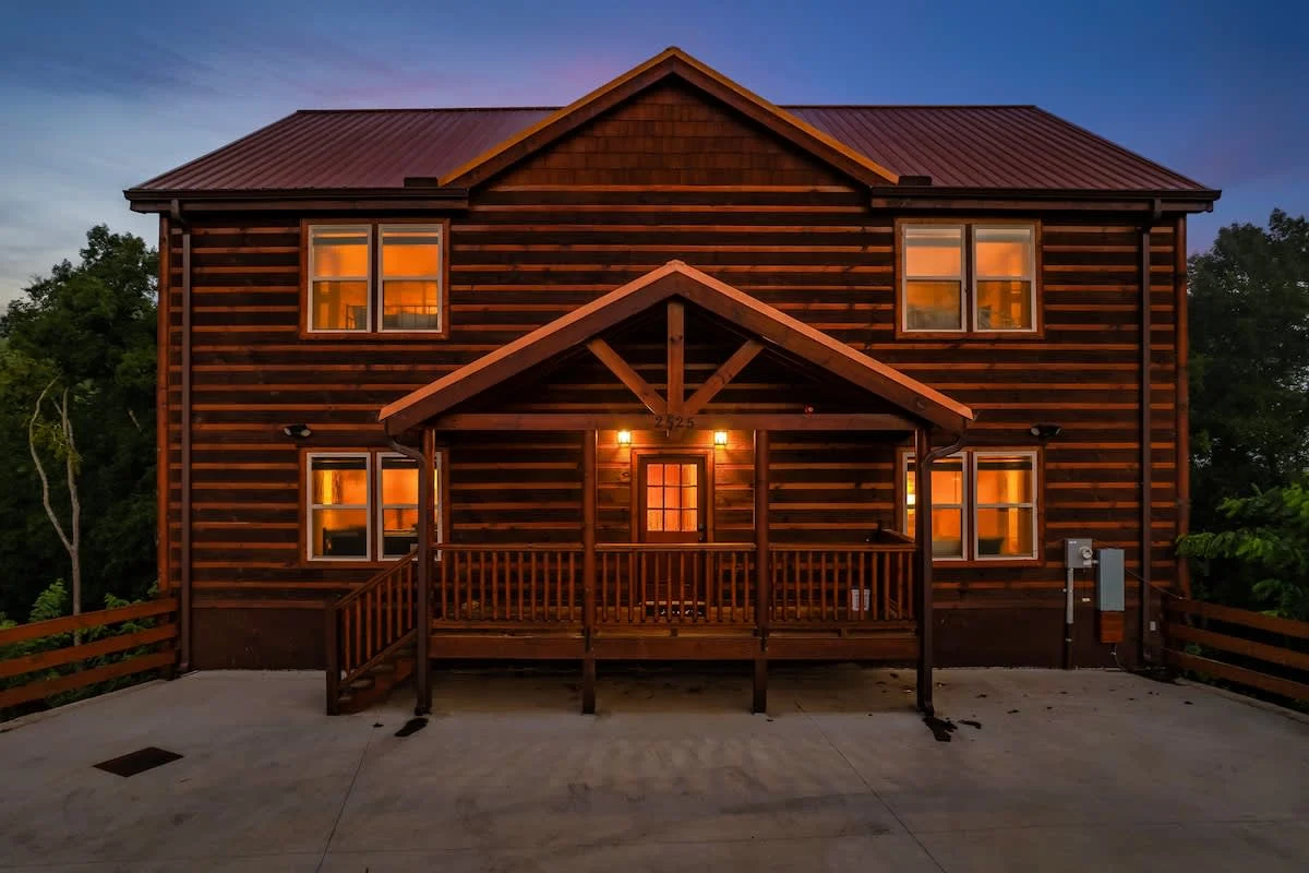 Blue Smoke Lodge front elevation at dusk, windows lit, Sevierville Tennessee