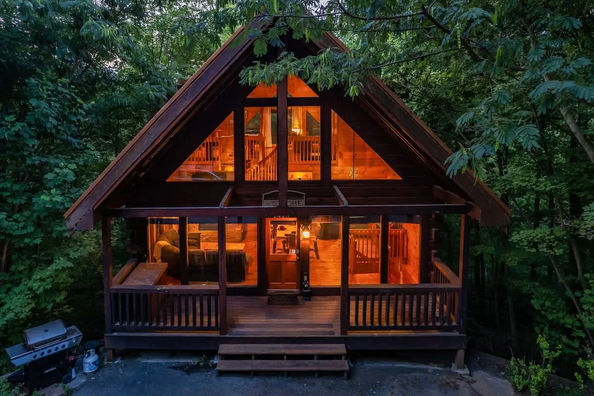 Break Point Lodge — cabin exterior glowing at dusk, Sevierville TN
