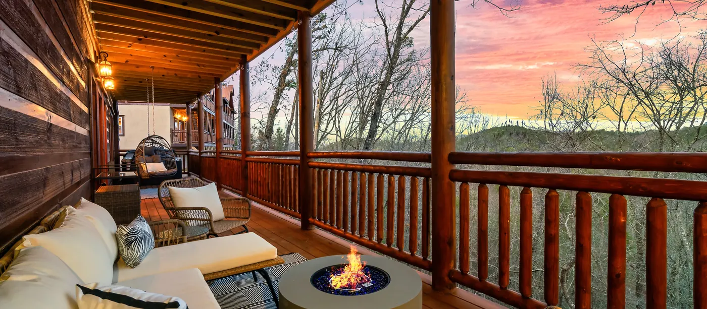 Fire pit and chairs outside a cabin at dusk