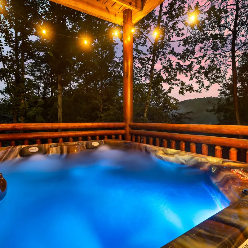 Hot tub under string lights at dusk