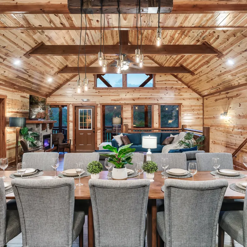 Dining room with a long table under a timber ceiling
