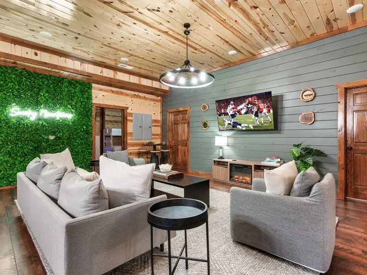 Living room with living wall and neon sign