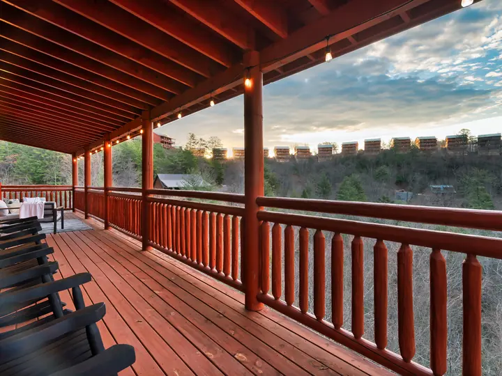 Covered deck with rocking chairs at sunset