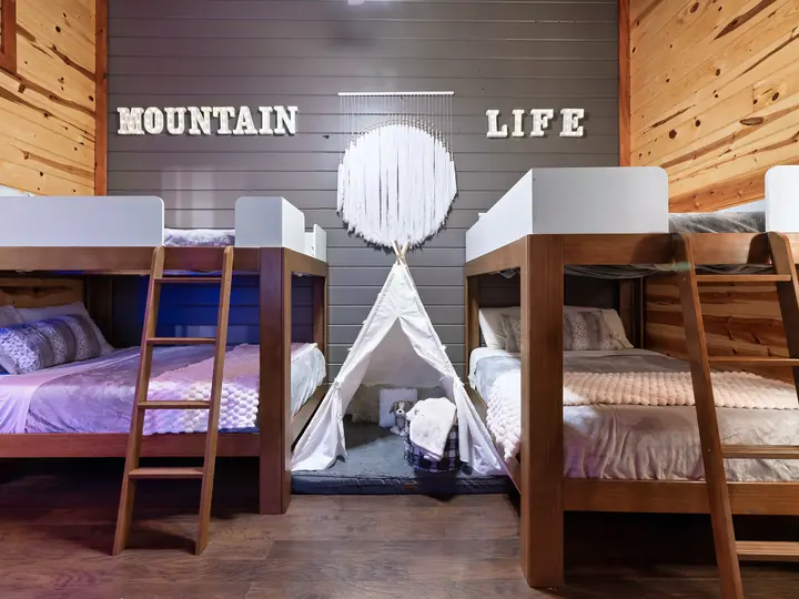 Bunk room with a play tent