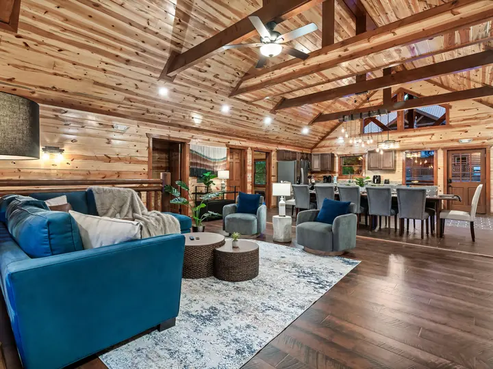 Great room with blue sectional and vaulted ceiling