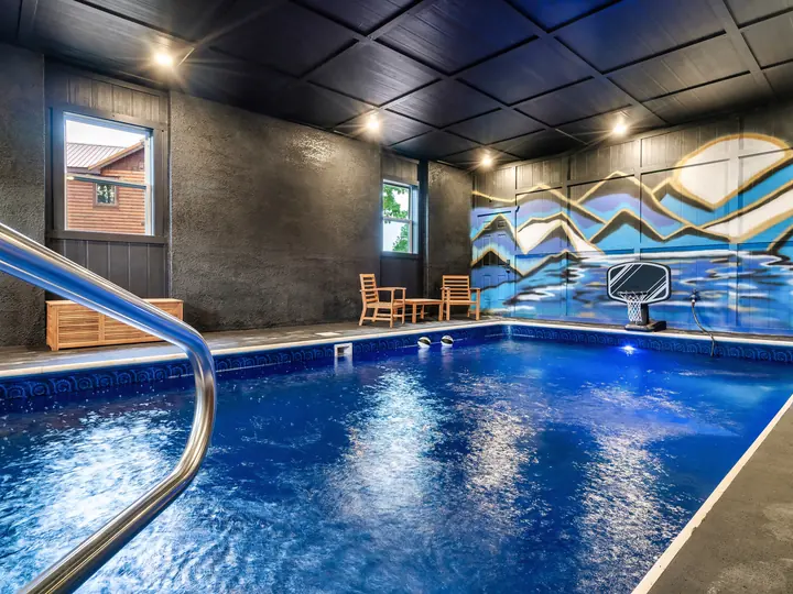 Indoor pool with painted mountain mural