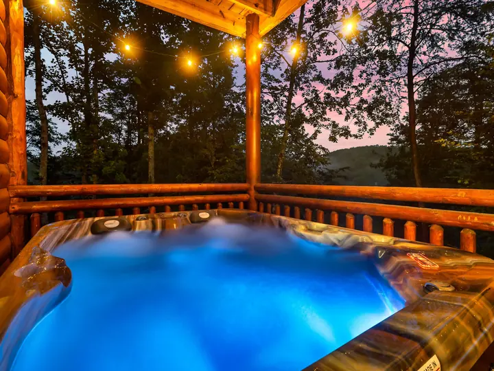 Hot tub under string lights at dusk