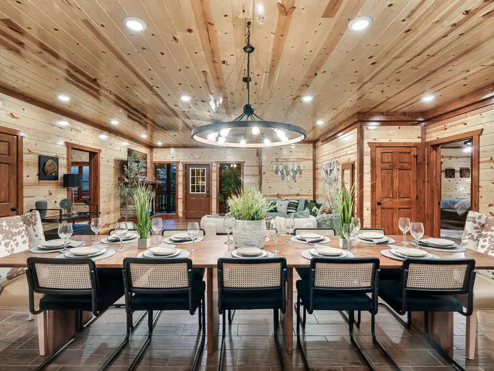 Dining room with a long table under a wood ceiling